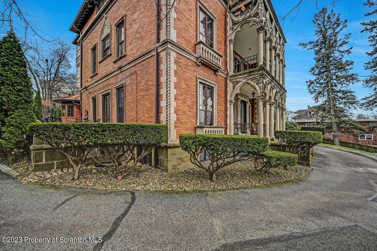 1000 Clay Avenue Scranton, PA 18510 - Photo 7 of 90 front view of a brick house with a bench in front of it