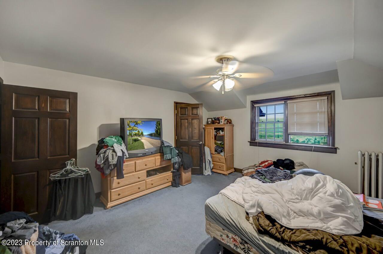 1000 Clay Avenue Scranton, PA 18510 - Photo 74 of 90 a bedroom with bed and a chandelier