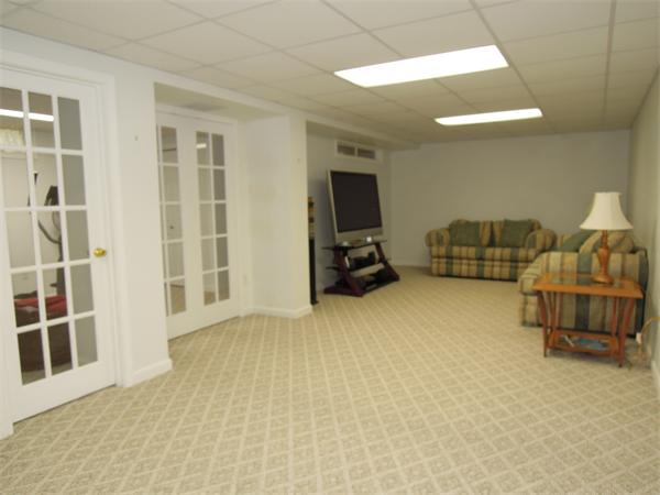 76 Stonegate Road, Unit 76 Chelmsford, MA 01824 - Photo 18 of 23 a bedroom with furniture and a flat screen tv