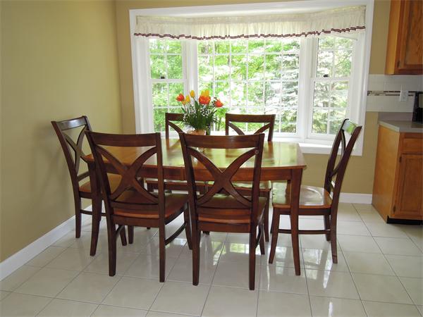 76 Stonegate Road, Unit 76 Chelmsford, MA 01824 - Photo 4 of 23 a view of a dining room with furniture and a window
