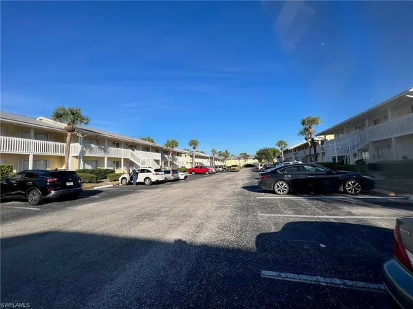 a view of cars parked in front of a building