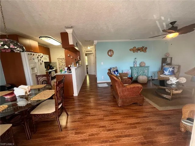 a dining room with furniture and wooden floor