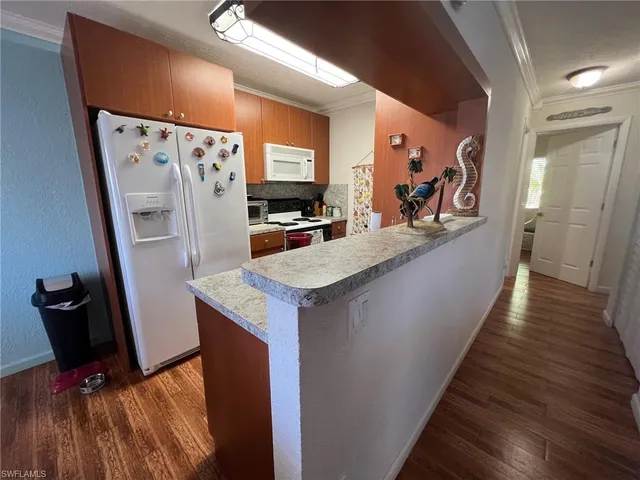 a view of a kitchen from the hallway