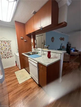 a kitchen with a stove top oven a sink a counter space and cabinets