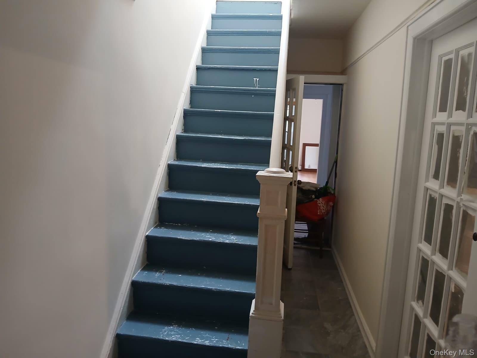 88-10 78th Street Queens, NY 11421 - Photo 8 of 12 Stairway with baseboards