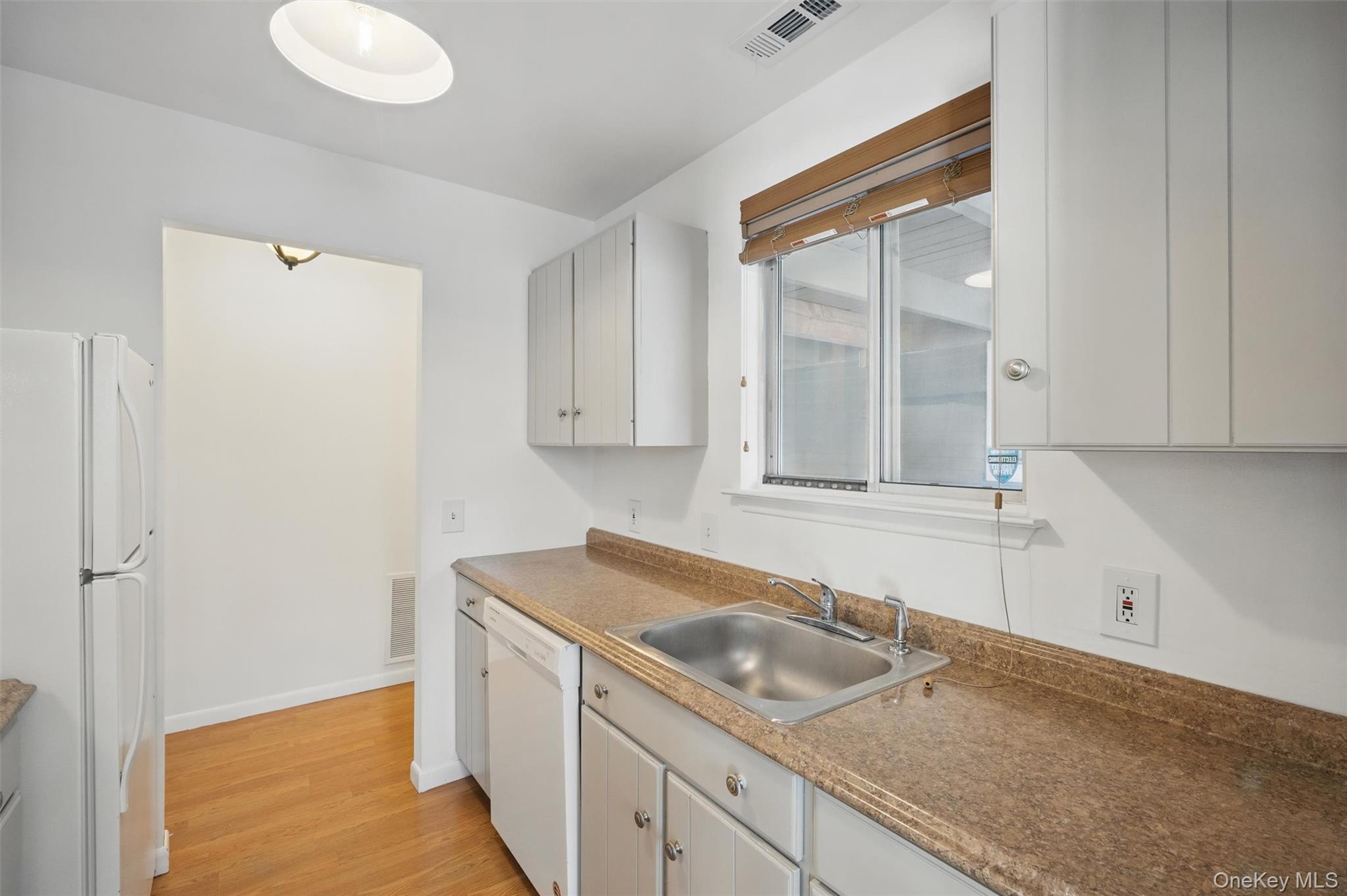 201 Commons Way, Unit E Fishkill, NY 12524 - Photo 16 of 30 Kitchen featuring white appliances and light wood finished floors