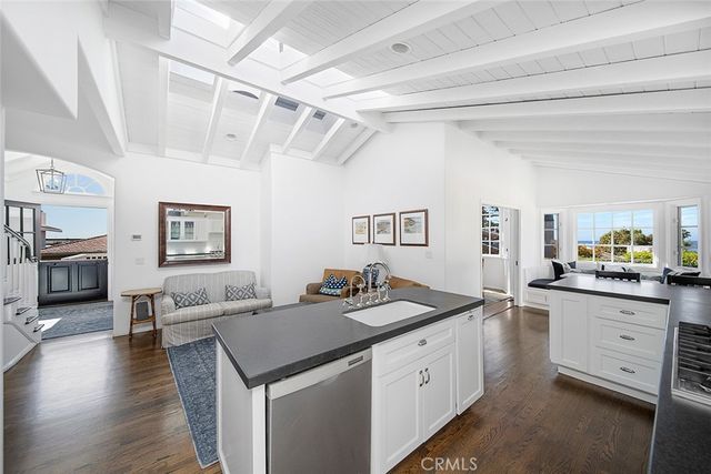 a kitchen with granite countertop a sink stove and cabinets