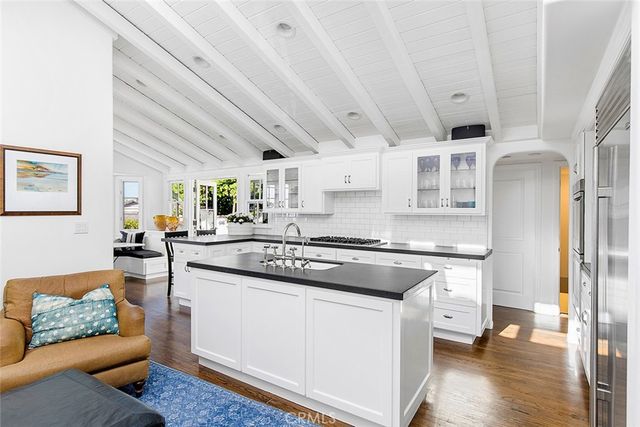 a kitchen with stainless steel appliances granite countertop a stove a sink and a refrigerator