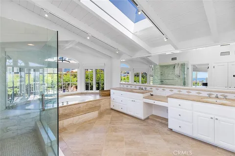 a large kitchen with kitchen island a large window
