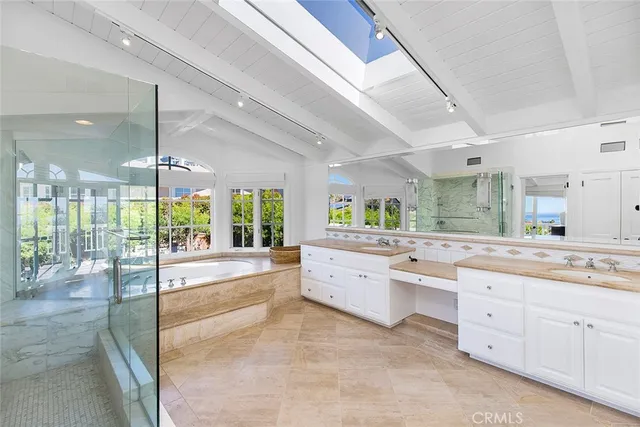 a large kitchen with kitchen island a large window