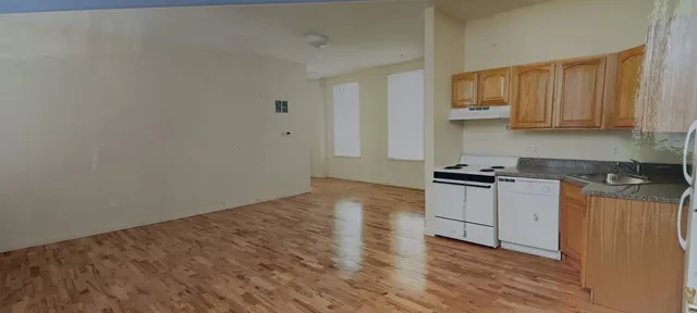 a kitchen with granite countertop a stove and a sink