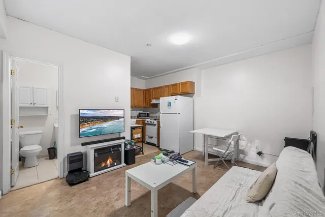 a bedroom with furniture and a flat screen tv