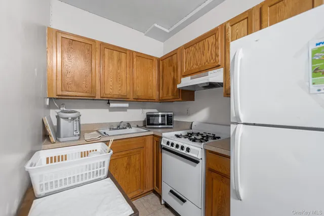 a kitchen with stainless steel appliances granite countertop a stove a refrigerator and a sink