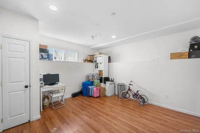a bedroom with furniture and a wooden floor