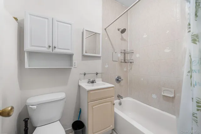 a bathroom with a toilet sink and shower