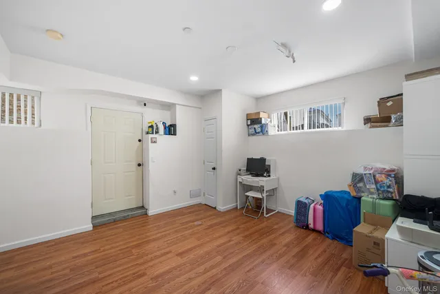 a room with a bed and a wooden floor