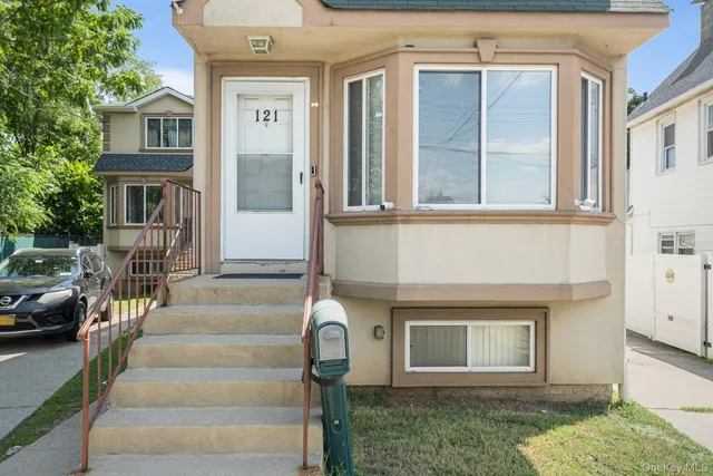 a front view of a house with a garden