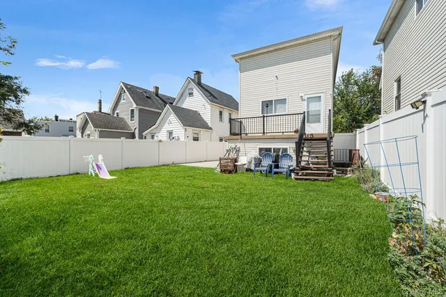 a view of backyard of house with green space