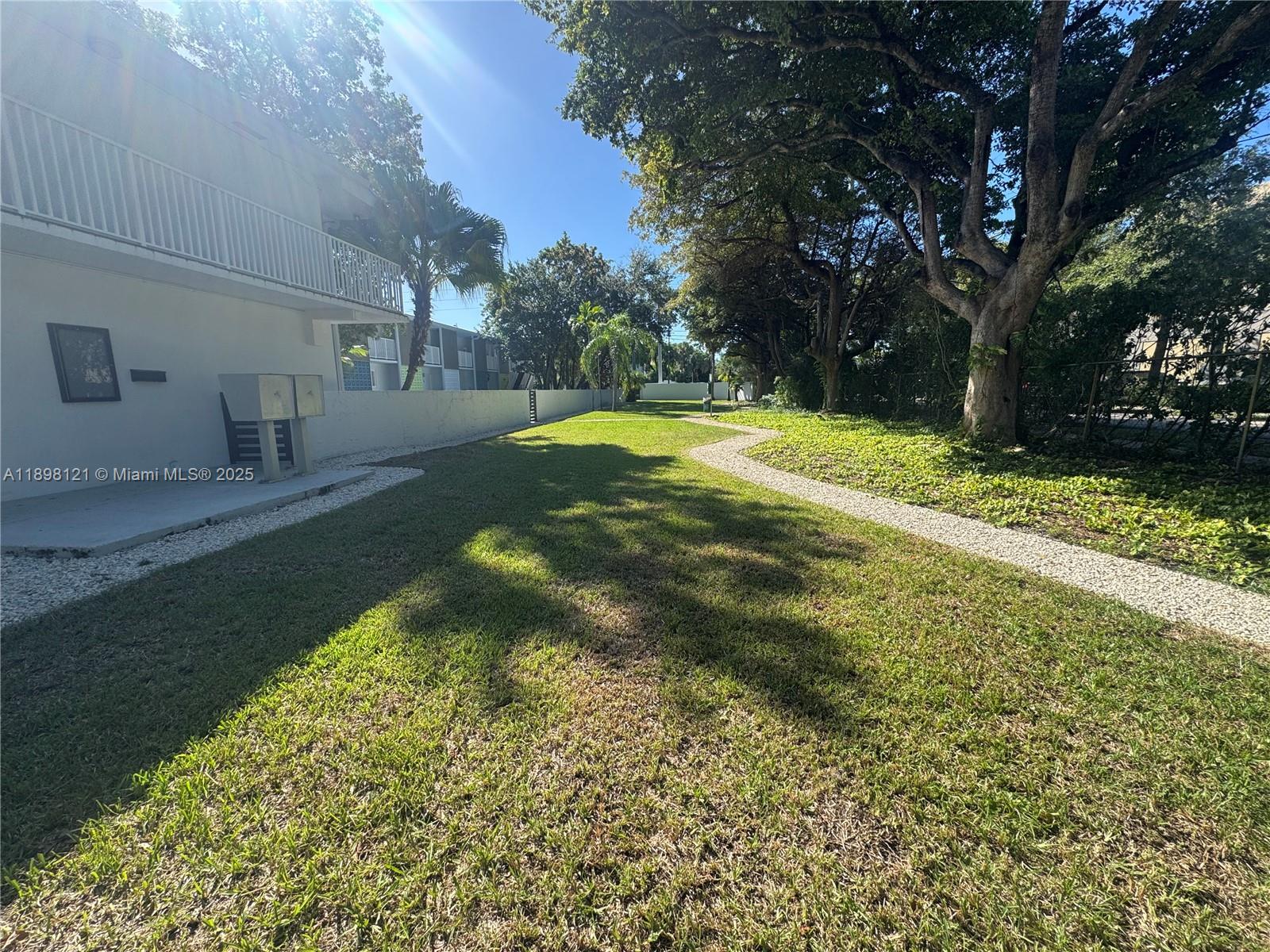 6805 Southwest 88th Street, Unit 12 Pinecrest, FL 33156 - Photo 15 of 18 a view of yard with swimming pool