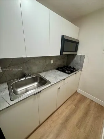 a kitchen with a sink and a microwave