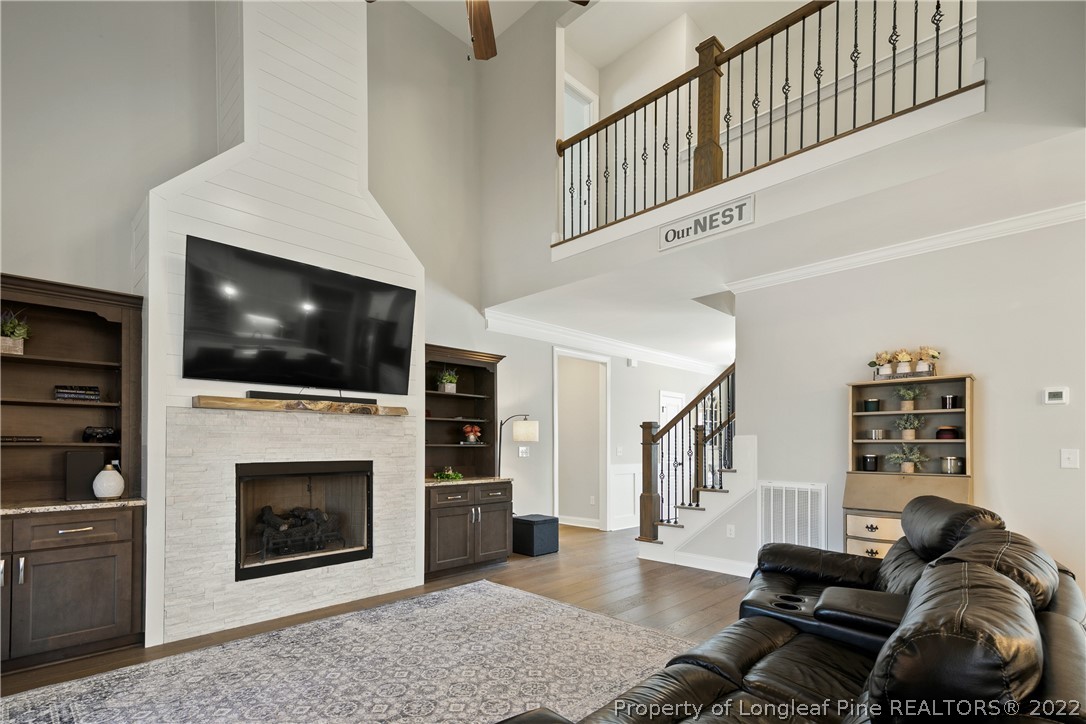 46 Brookhill Court Spring Lake, NC 28390 - Photo 11 of 50 a living room with furniture a flat screen tv and a fireplace