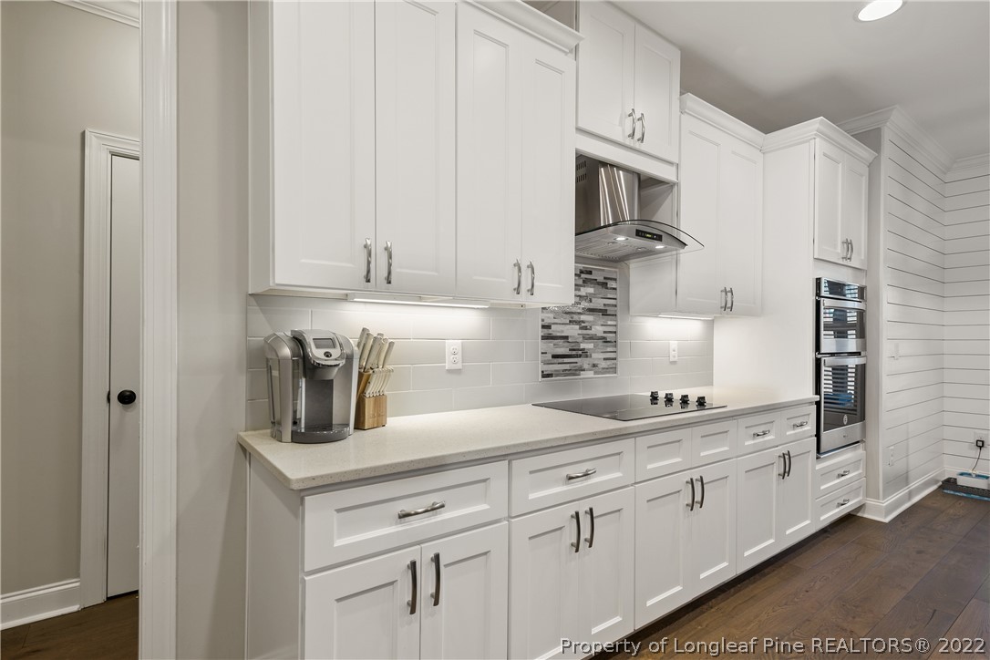 46 Brookhill Court Spring Lake, NC 28390 - Photo 17 of 50 a kitchen with granite countertop white cabinets and stainless steel appliances