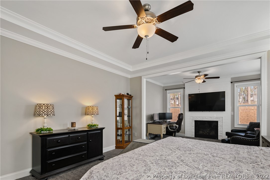 46 Brookhill Court Spring Lake, NC 28390 - Photo 22 of 50 a view of a livingroom with a flat screen tv ceiling fan and a fireplace