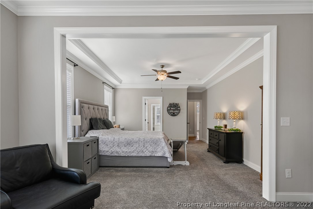 46 Brookhill Court Spring Lake, NC 28390 - Photo 24 of 50 a bedroom with furniture and a chandelier