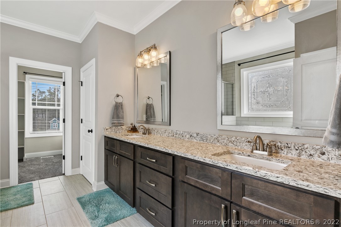 46 Brookhill Court Spring Lake, NC 28390 - Photo 25 of 50 a bathroom with double vanity sinks and a mirror