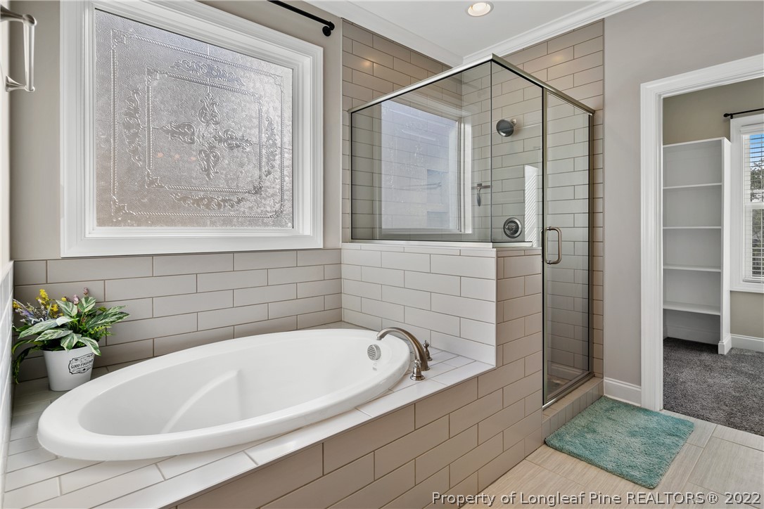 46 Brookhill Court Spring Lake, NC 28390 - Photo 26 of 50 a white bath tub sitting next to a shower