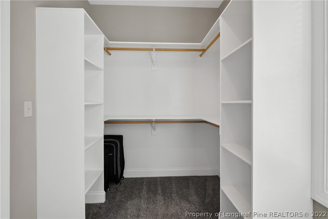 46 Brookhill Court Spring Lake, NC 28390 - Photo 27 of 50 a view of walk in closet with clothes