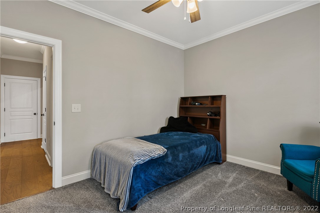 46 Brookhill Court Spring Lake, NC 28390 - Photo 30 of 50 a bedroom with a bed and a chandelier