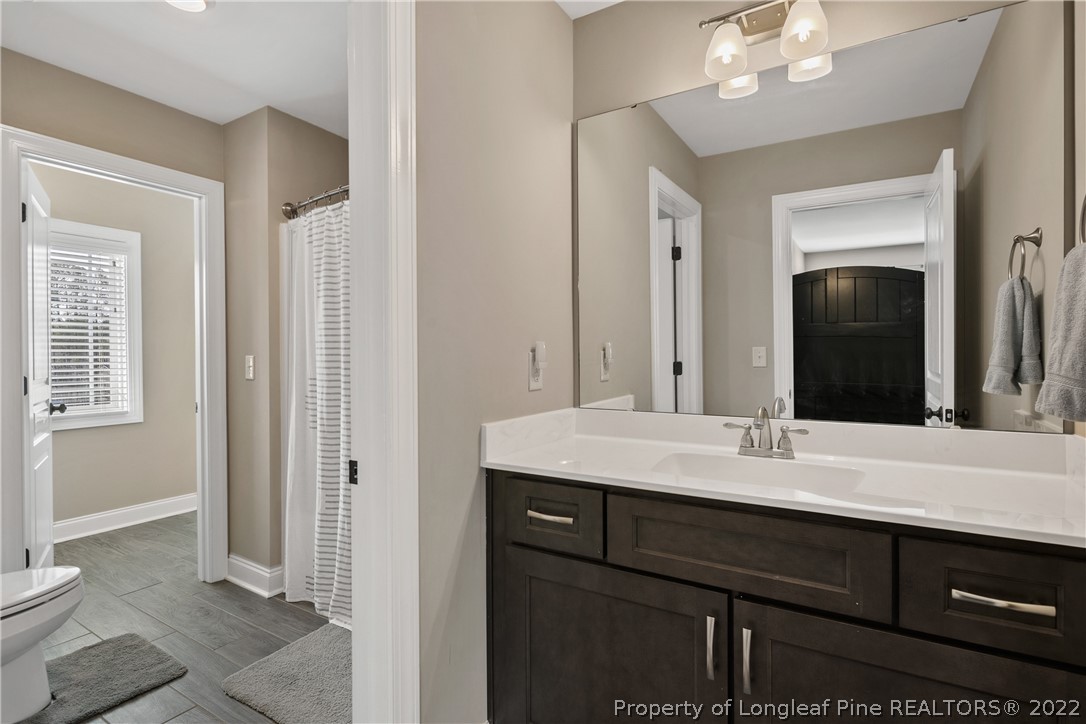 46 Brookhill Court Spring Lake, NC 28390 - Photo 38 of 50 a bathroom with a sink vanity granite and a mirror