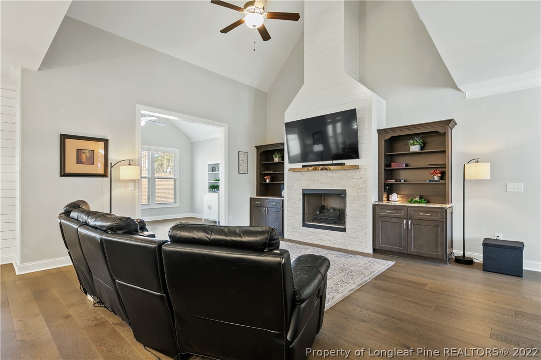 46 Brookhill Court Spring Lake, NC 28390 - Photo 10 of 50 a living room with furniture a flat screen tv and a fireplace