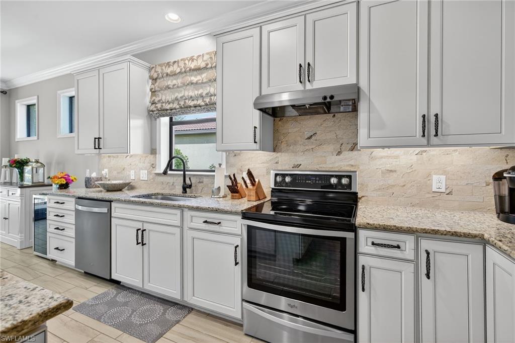 5215 Ciatto Way Ave Maria, FL 34142 - Photo 10 of 46 a kitchen with granite countertop white cabinets and white appliances