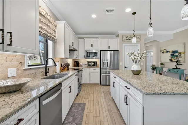 a bathroom with a granite countertop double vanity sink and mirror