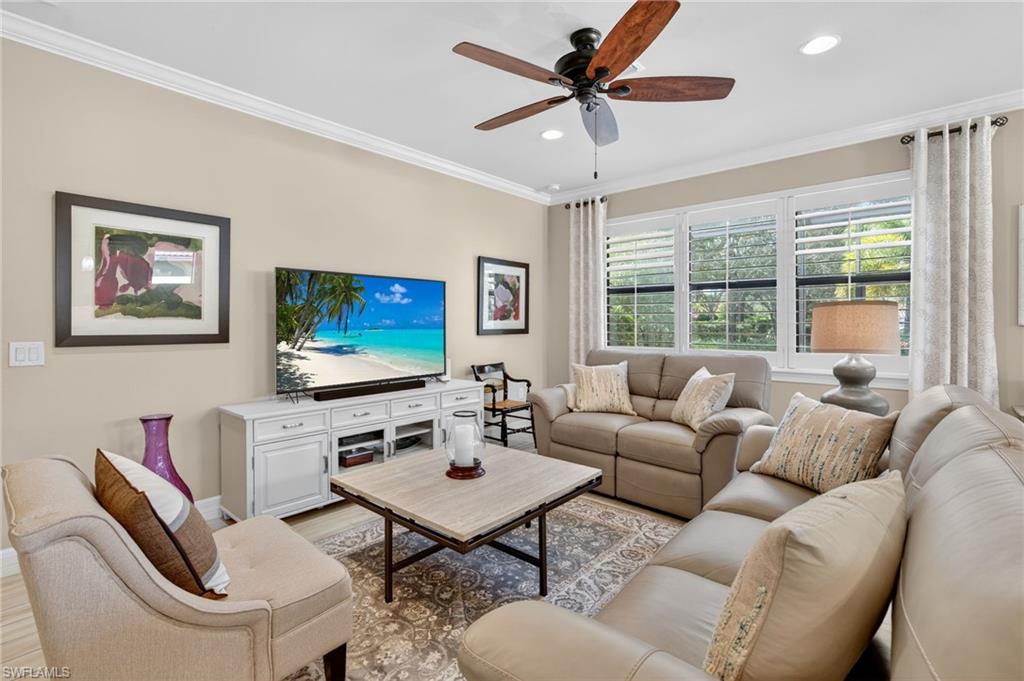 5215 Ciatto Way Ave Maria, FL 34142 - Photo 15 of 46 a living room with furniture a large window and a flat screen tv