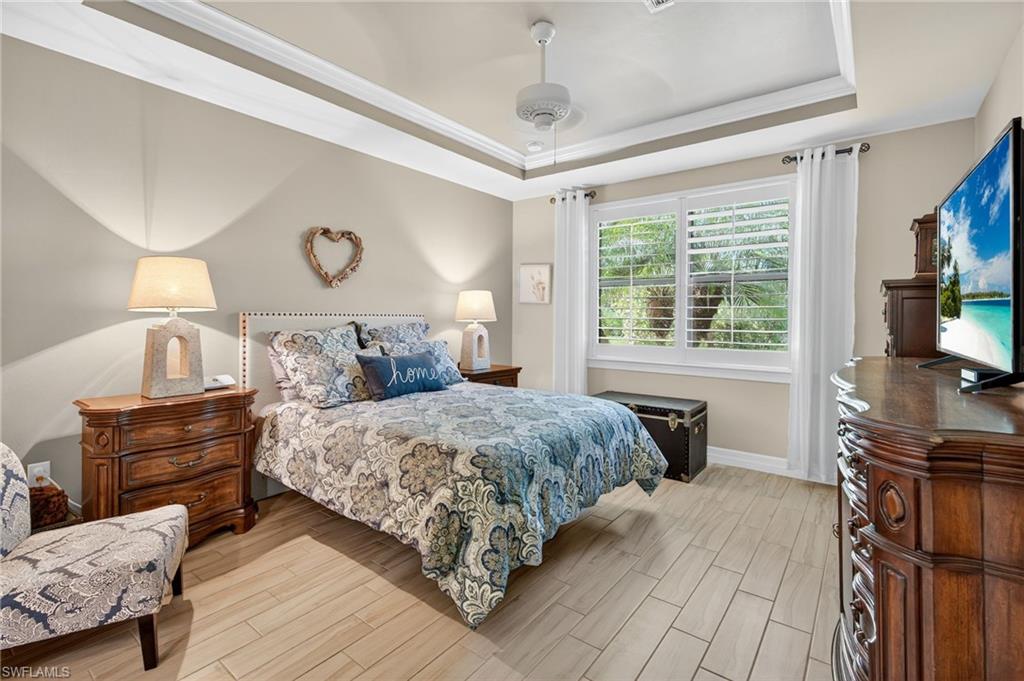 5215 Ciatto Way Ave Maria, FL 34142 - Photo 16 of 46 a bedroom with a bed and wooden floor