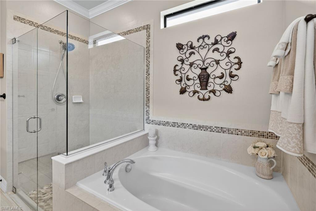 5215 Ciatto Way Ave Maria, FL 34142 - Photo 18 of 46 a bathroom with a bathtub and shower