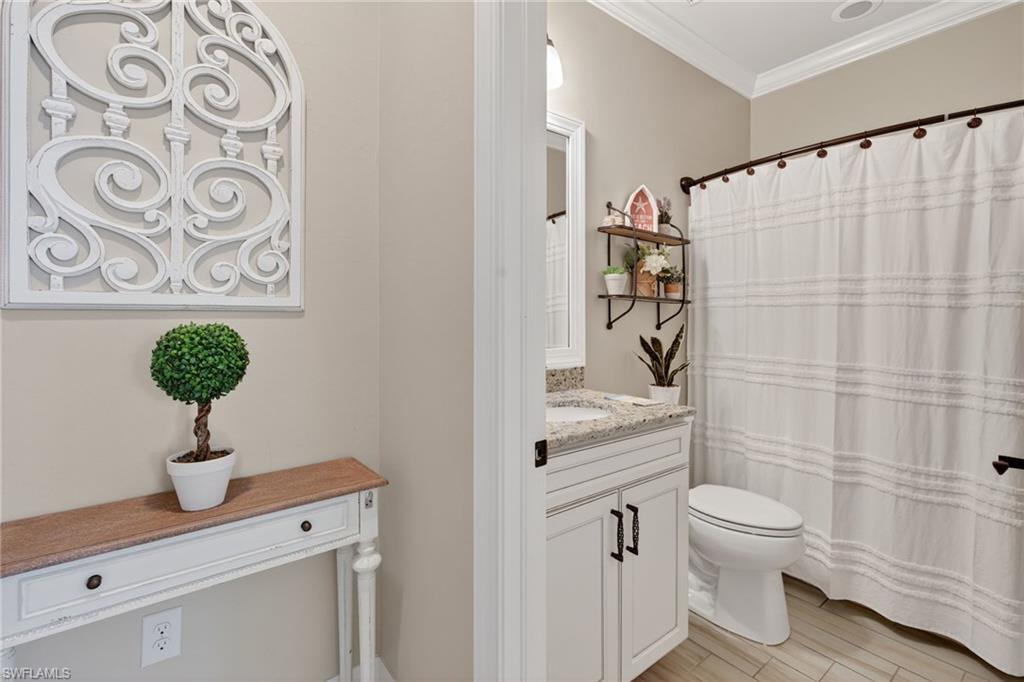 5215 Ciatto Way Ave Maria, FL 34142 - Photo 21 of 46 a bathroom with a toilet and a shower curtain