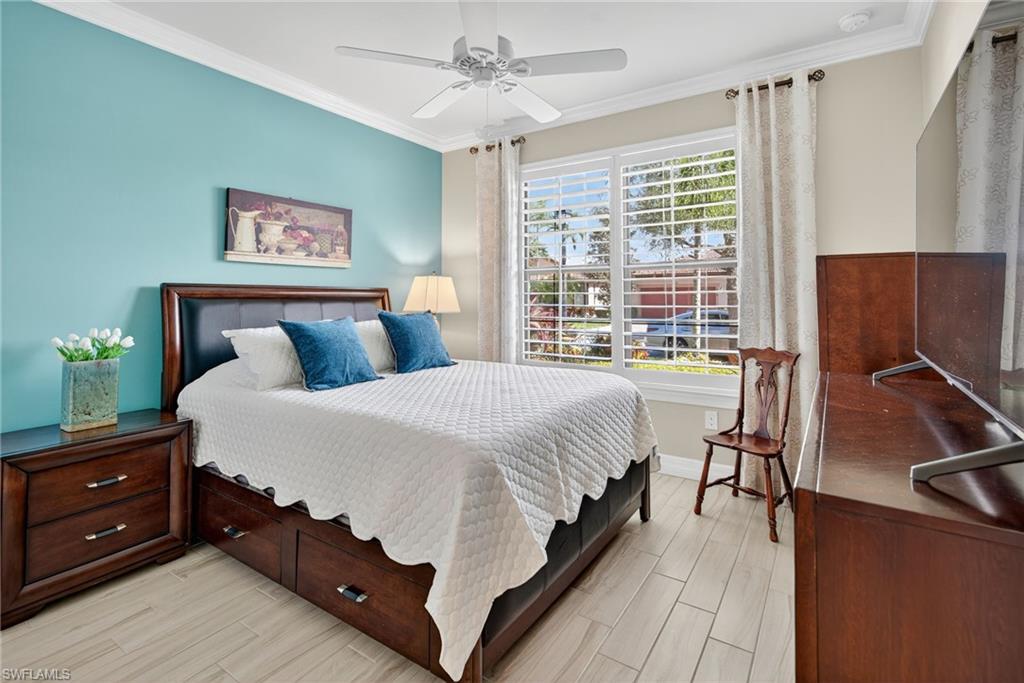 5215 Ciatto Way Ave Maria, FL 34142 - Photo 23 of 46 a bedroom with a bed and a flat tv screen on dresser