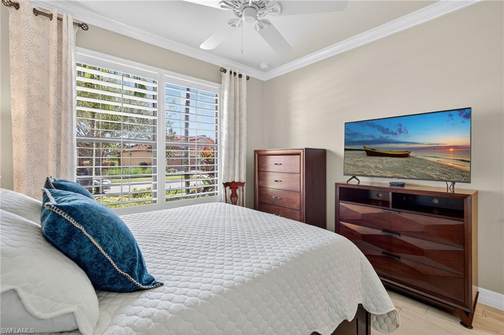 5215 Ciatto Way Ave Maria, FL 34142 - Photo 24 of 46 a bedroom with a bed and a large window