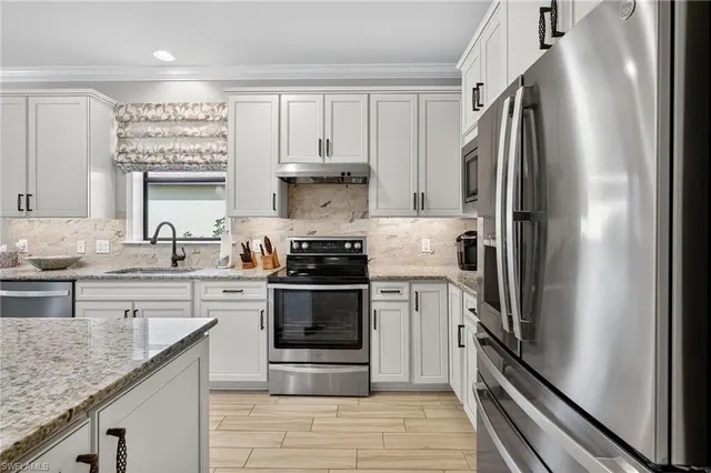 a living room with furniture a large window and a flat screen tv