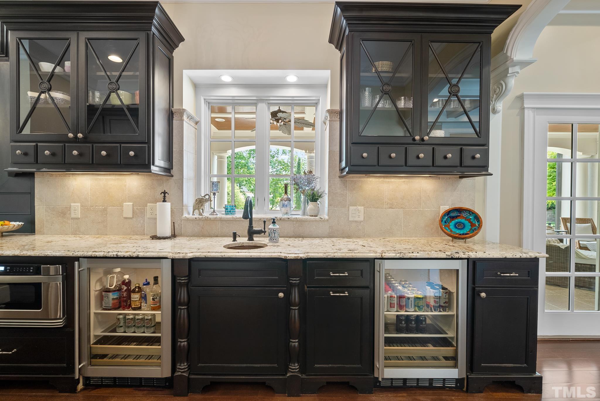 1204 Hedgelawn Way Raleigh, NC 27615 - Photo 12 of 44 a kitchen with stainless steel appliances granite countertop a sink and a wooden cabinets