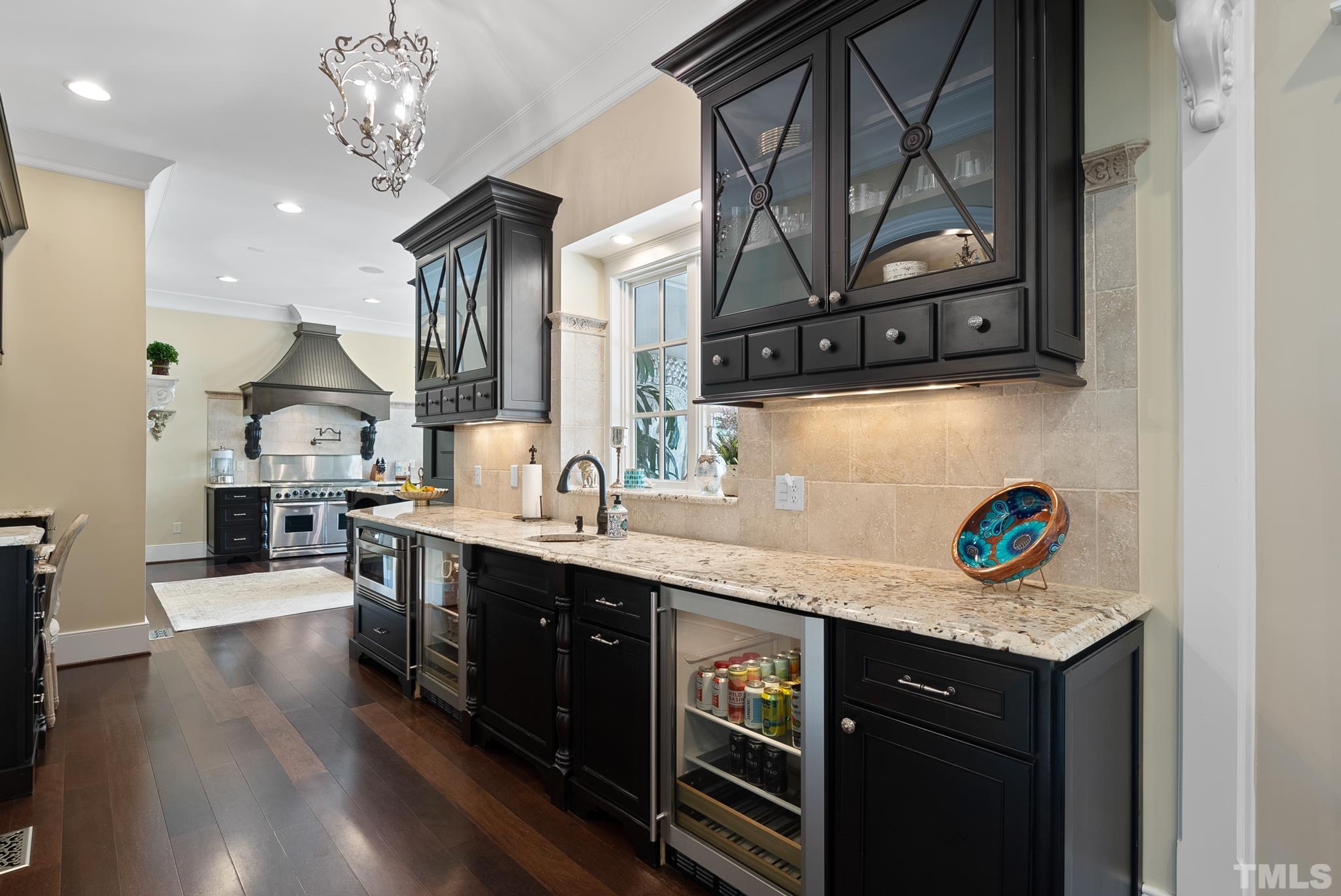 1204 Hedgelawn Way Raleigh, NC 27615 - Photo 13 of 44 a kitchen with stainless steel appliances granite countertop a sink a stove a microwave a counter top and cabinets