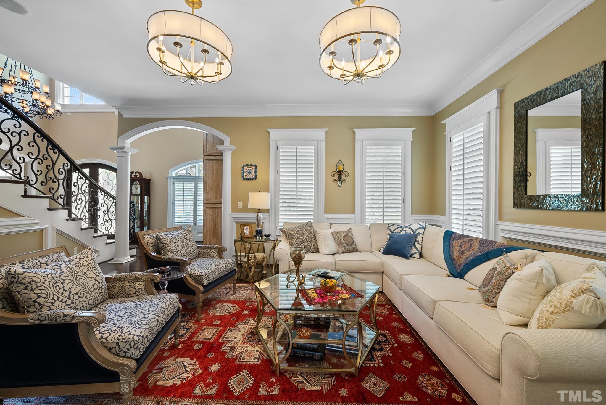 1204 Hedgelawn Way Raleigh, NC 27615 - Photo 15 of 44 a living room with furniture a chandelier and a large mirror