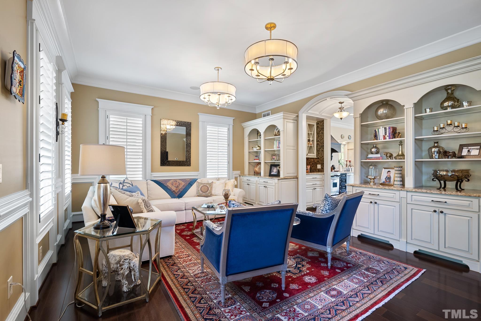 1204 Hedgelawn Way Raleigh, NC 27615 - Photo 16 of 44 a view of a dining room with furniture a rug and wooden floor