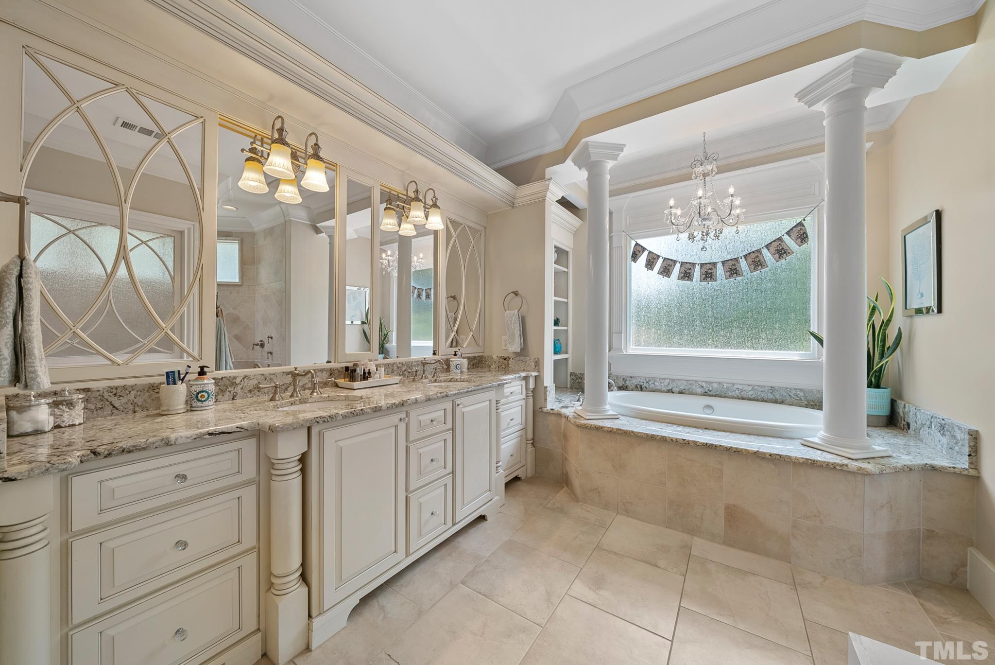 1204 Hedgelawn Way Raleigh, NC 27615 - Photo 22 of 44 a bathroom with a double vanity sink mirror and a bathtub