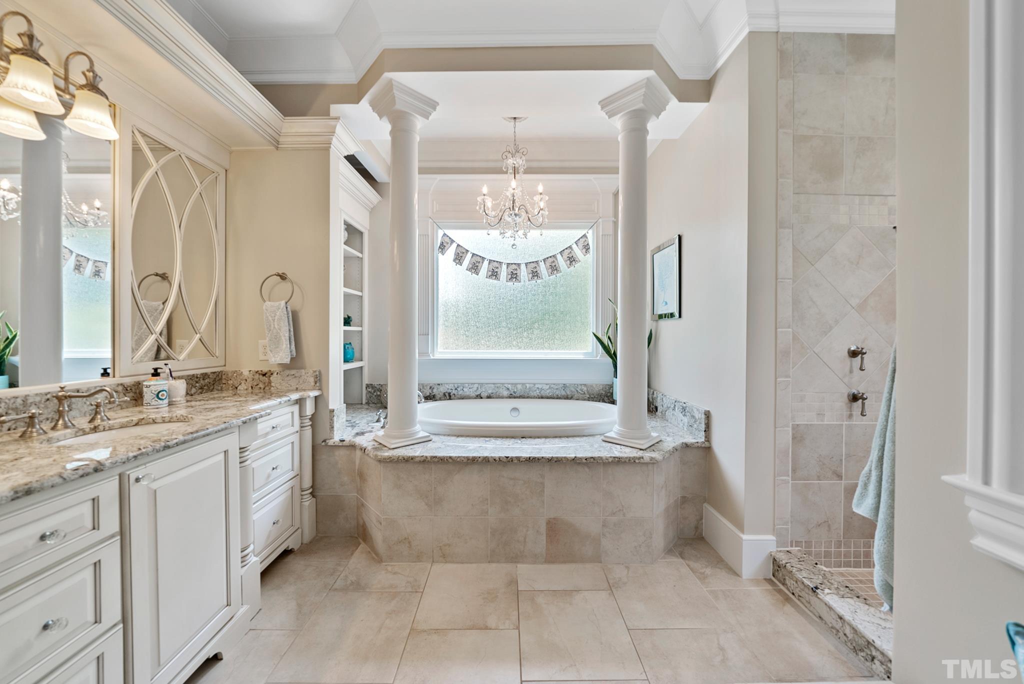 1204 Hedgelawn Way Raleigh, NC 27615 - Photo 23 of 44 a bathroom with a granite countertop sink a large mirror and a bathtub