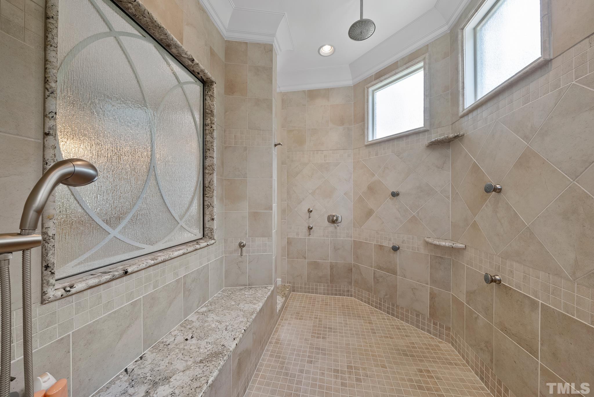 1204 Hedgelawn Way Raleigh, NC 27615 - Photo 24 of 44 a bathroom with a glass shower door